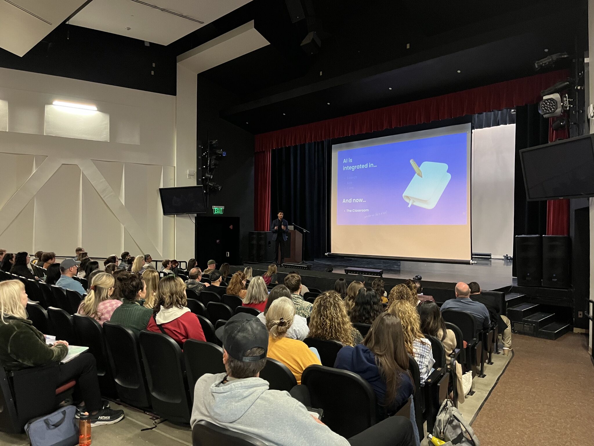 Christian Jackson delivering a keynote in an auditorium