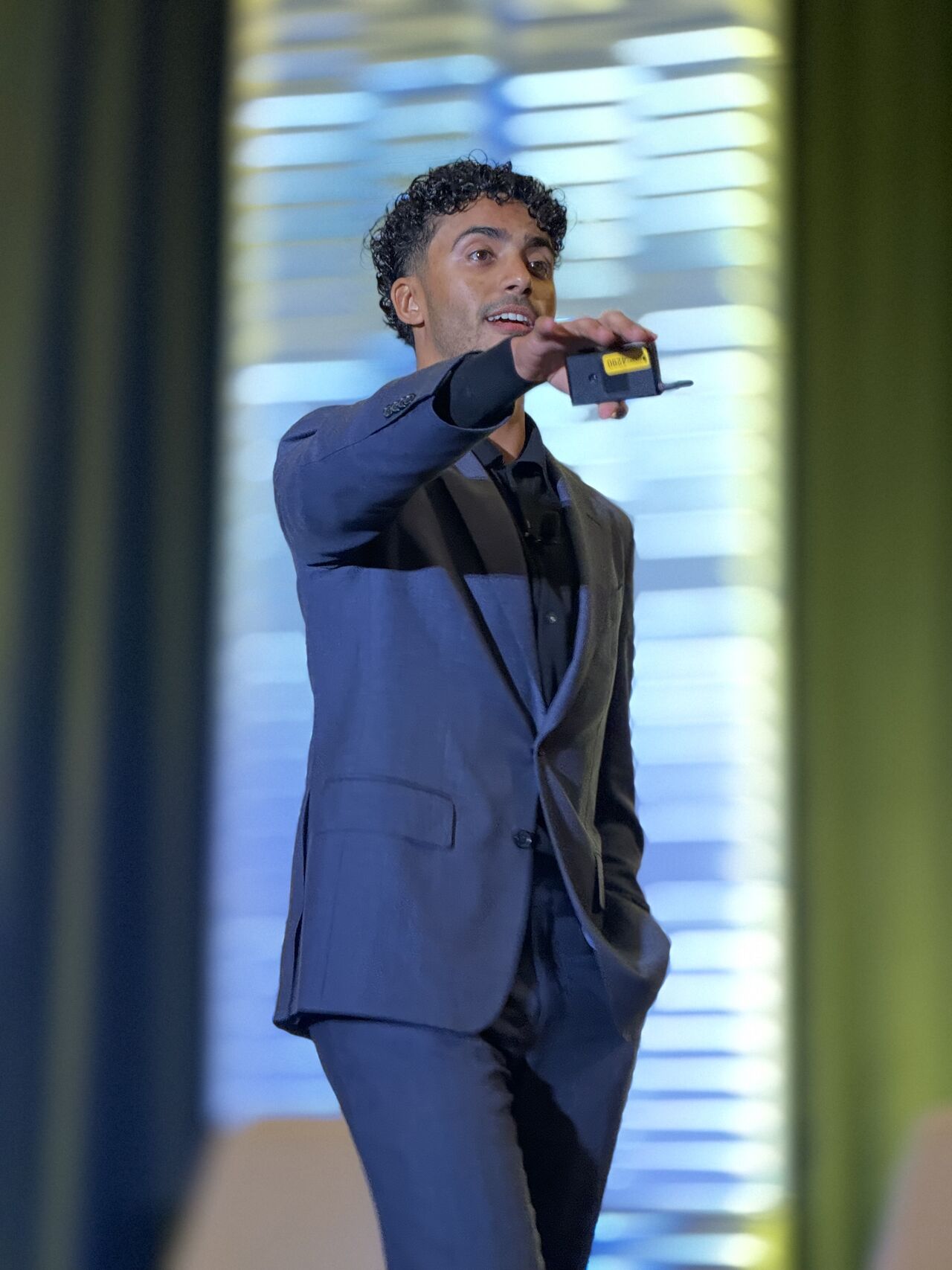 Christian Jackson on stage, framed by curtains from the wings